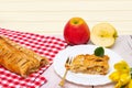 Apple roll served. A roll of homemade baked fresh apple strudel with an appetizing slice of apple pie on the plate fresh apples