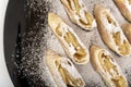 Apple roll or strudel with powdered sugar on black plate. Close up Royalty Free Stock Photo