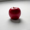 Apple\'s shiny texture, casting a soft shadow on the surface, suggestin Royalty Free Stock Photo