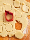 Apple shaped cookie cutter on raw cookie dough