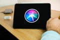 Apple Siri logo on the screen of iPad tablet. March 2021, San Francisco, USA