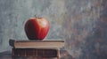 Apple sitting on top of a stack of books on top Royalty Free Stock Photo