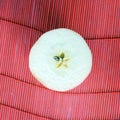 Apple slice on red straw