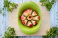 Apple slicer with red apple cutted into eight pieces on cutting board Royalty Free Stock Photo