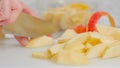 Apple slices, and apple peel close-up on a white cutting board. Woman slicing apples, apple cake recipe Royalty Free Stock Photo