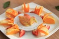 Apple slices arrangement, fresh fruit platter on wooden tabletop, healthy diet