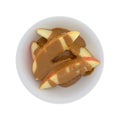 Apple slices covered with peanut butter on a white background Royalty Free Stock Photo