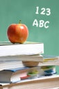 Apple on stack of books in classroom Royalty Free Stock Photo