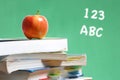 Apple on stack of books in classroom Royalty Free Stock Photo