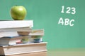 Apple on stack of books in classroom Royalty Free Stock Photo