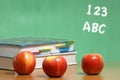 Apple on stack of books in classroom Royalty Free Stock Photo