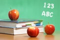 Apple on stack of books in classroom Royalty Free Stock Photo