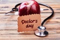 Apple, stethoscope and greeting card. Royalty Free Stock Photo