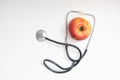 apple and stetoskop on a white background. Royalty Free Stock Photo