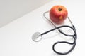 apple and stetoskop on a white background. Royalty Free Stock Photo