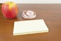 An apple, stickers, measuring tape, lie on the table. Royalty Free Stock Photo