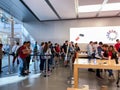 An Apple store with people waiting in line to purchase the latest Apple iPhone 11