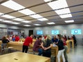 An Apple store with people waiting to purchase Apple Macbooks, iPads and iPhones Royalty Free Stock Photo