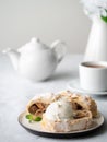 Apple strudel with ice cream and cinnamon. Baked cake and tea, delicious dessert on the table. Side view, vertical Royalty Free Stock Photo