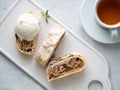 Apple strudel with ice cream and cinnamon. Baked cake and tea, delicious dessert on the table. Top view Royalty Free Stock Photo
