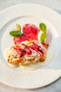 Apple strudel table raisins ice cream mint sultana berries sauce red green white plate close up top view Royalty Free Stock Photo