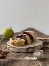 Apple strudel with walnuts on a light background