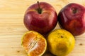 Apple & tangerine on wood background Royalty Free Stock Photo