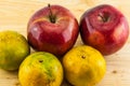 Apple & tangerine on wood background Royalty Free Stock Photo