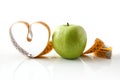 Apple and tape measure next to it forming a heart Royalty Free Stock Photo