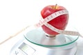 Apple and tape measure on a scale Royalty Free Stock Photo