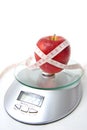 Apple and tape measure on a scale Royalty Free Stock Photo