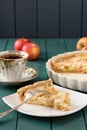 Apple tart with cup of tea and whole apples Royalty Free Stock Photo