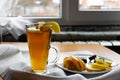 Apple tea in a transparent glass with a handle, the drink is decorated with slices of fresh apple with a yellow peel, next to the Royalty Free Stock Photo