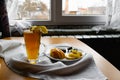 Apple tea in a transparent glass with a handle, the drink is decorated with slices of fresh apple with a yellow peel, next to the Royalty Free Stock Photo