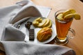 Apple tea in a transparent glass with a handle, the drink is decorated with slices of fresh apple with a yellow peel, next to the Royalty Free Stock Photo