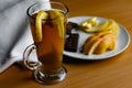 Apple tea in a transparent glass with a handle, the drink is decorated with slices of fresh apple with a yellow peel, next to the Royalty Free Stock Photo