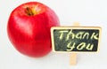 Apple with a Thank you inscription on a wooden Board black background