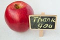 Apple with a Thank you inscription on a wooden Board black background