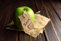 Apple with thank you lable on a piece of burlap over dark wooden background. Happy thanksgiving day concept.