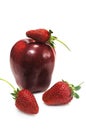 Apple with three ripe strawberry Royalty Free Stock Photo