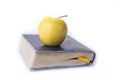 Apple on top of the old book on the white. Royalty Free Stock Photo