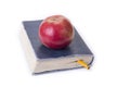 Apple on top of the old book on the white. Royalty Free Stock Photo