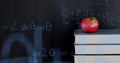 Apple on top of a pile of books and mathematical equations and graphs Royalty Free Stock Photo