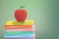 Apple on top stack books green background illustration vector. E Royalty Free Stock Photo