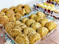 Apple turnover cakes in a tray with other cakes