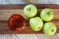 apple vinegar in glass bottle with fresh green apple on table