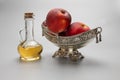 Apple vinegar in a glass bottle and fresh red apples in a vase Royalty Free Stock Photo