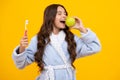 Apple vitamins for healthy teeth. Portrait of caucasian teen girl holds a toothbrush brushing her teeth, morning routine