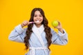 Apple vitamins for healthy teeth. Dental care, hygiene and child. Teenage girl with toothbrush brushing teeth. Royalty Free Stock Photo