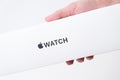 Apple watch box in woman hand on the grey background with copy space, December 2020, San Francisco, USA Royalty Free Stock Photo